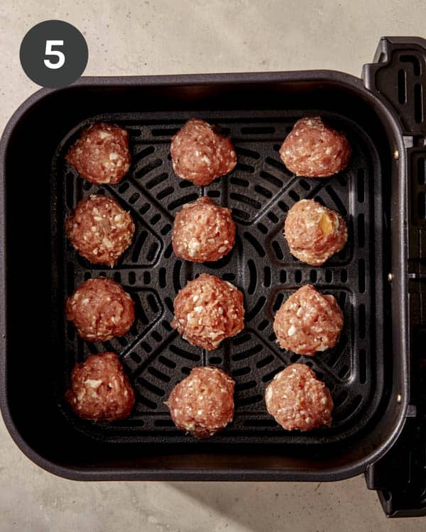 Turkey meatballs being cooked in an air fryer.