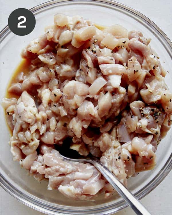 Chicken thighs in a bowl for chicken lettuce wraps recipe.