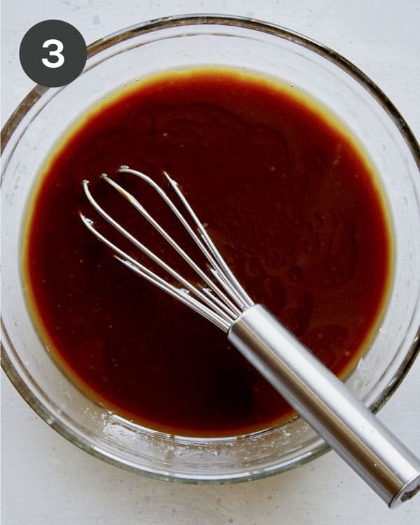 Cooking sauce in a glass bowl for chicken lettuce wraps.