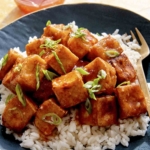 Crispy air fryer tofu in a bowl with rice.