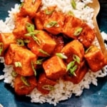 Crispy air fryer tofu with a sweet chili sauce on a bed of rice.