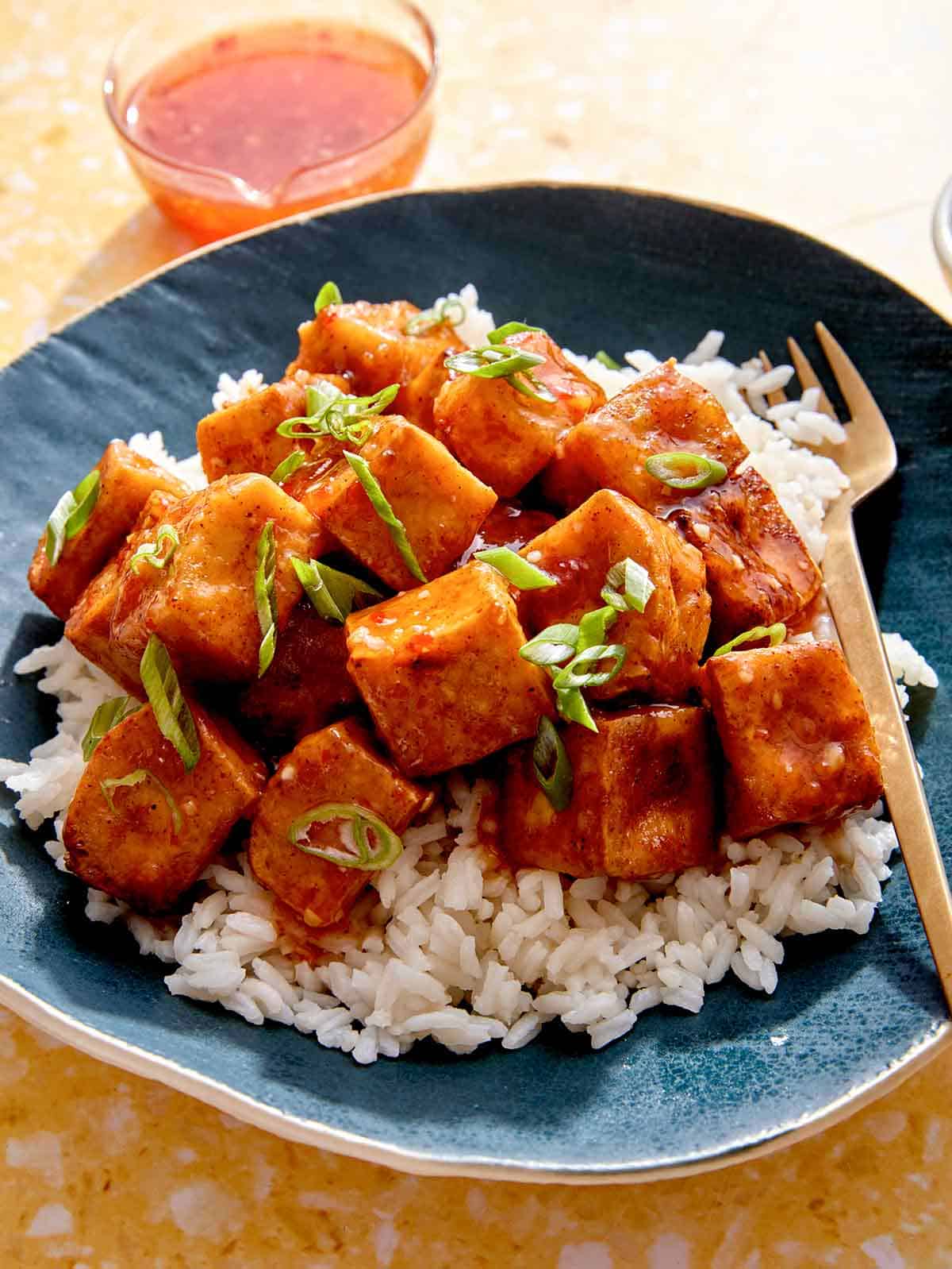 Crispy air fryer tofu in a bowl with rice. 