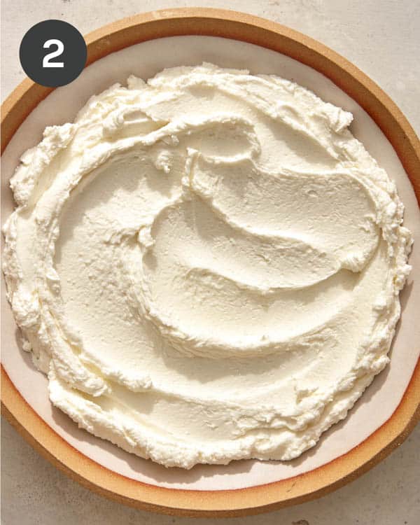 Whipped goat cheese in a bowl. 