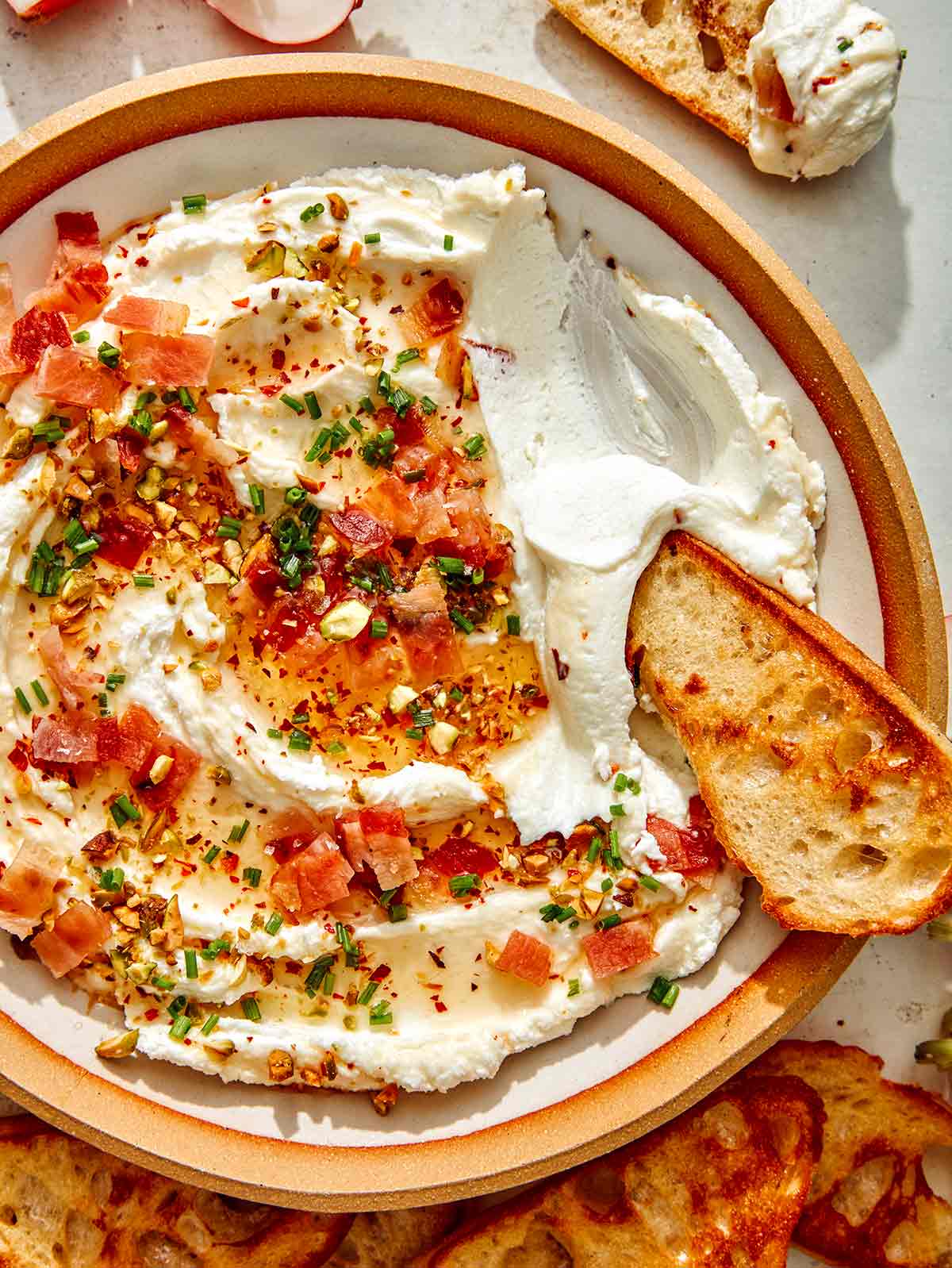 Whipped goat cheese with a crostini dipped in it. 