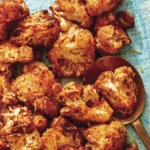 Air fryer cauliflower on a plate with a spoon.