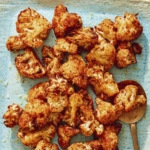 Air fryer cauliflower on a plate with a spoon.