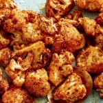 Air fryer cauliflower on a plate with a spoon.