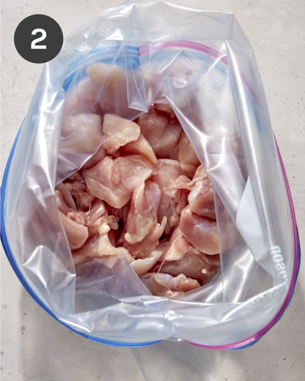 Chicken thighs in a bag cut up.