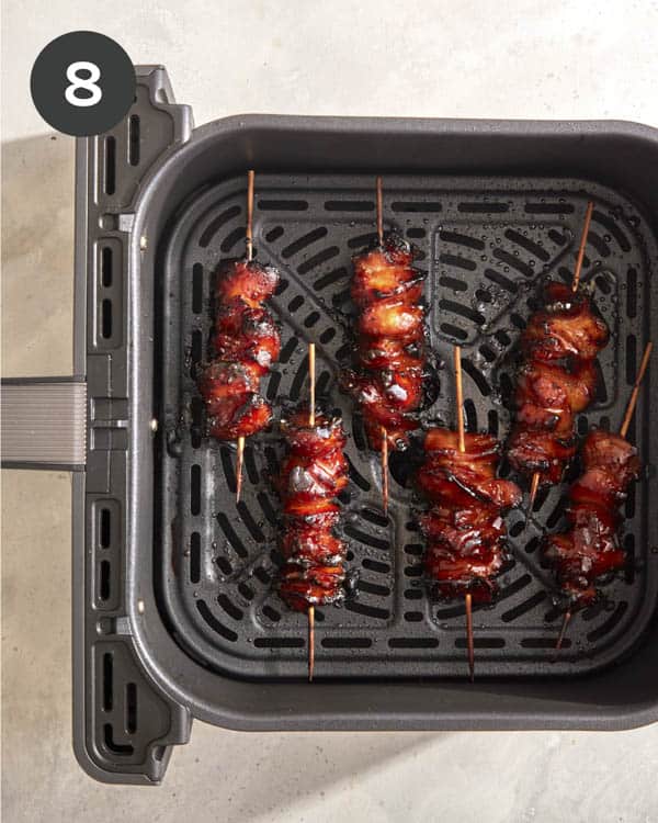 Air fryer chicken skewers being cooked.