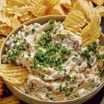 Baked potato dip in a bowl with potato chips on the side.