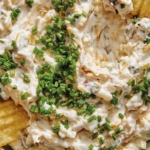 Baked potato dip recipe in a bowl with chips.
