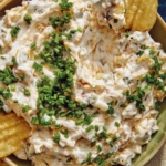 Baked potato dip recipe in a bowl with chips.