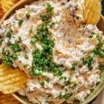 Baked potato dip recipe in a bowl with chips.