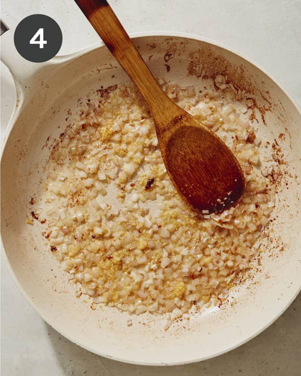 Garlic and onions cooked in a skillet.