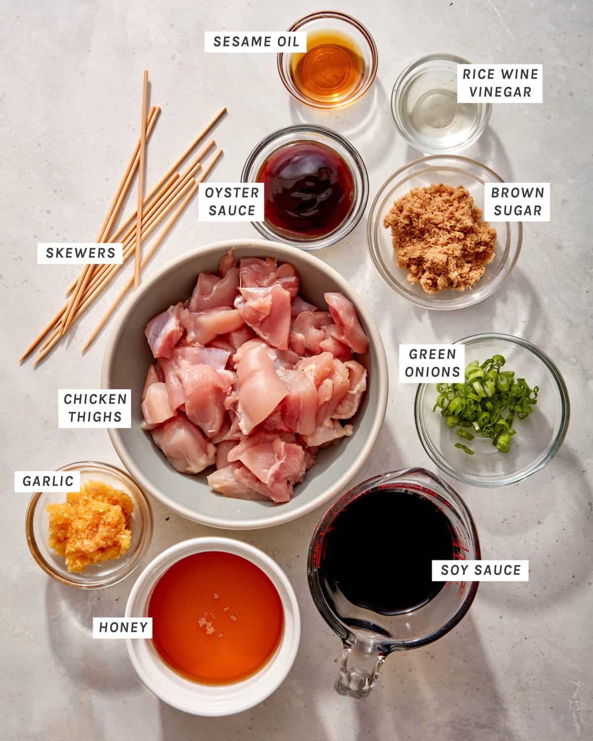 Ingredients to make garlic honey chicken skewers in a kitchen.