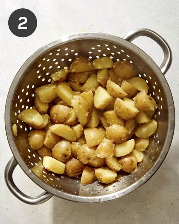 Potatoes draining in a colander.