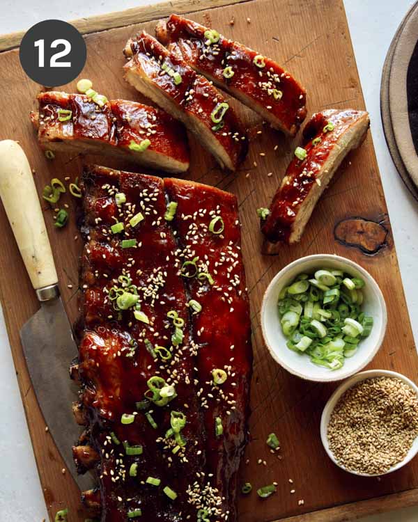 Honey hoisin oven baked ribs on a cutting board. 