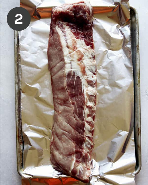 Ribs on a baking sheet with foil.