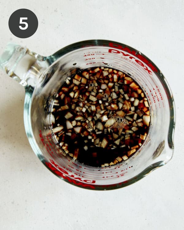 Oven baked ribs marinade ingredients in a measuring cup.