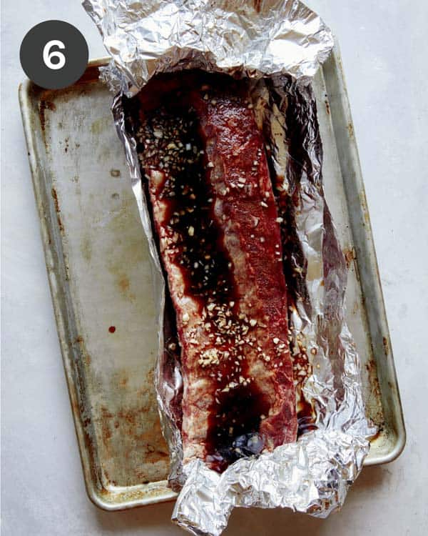 Oven baked ribs with marinade in tin foil