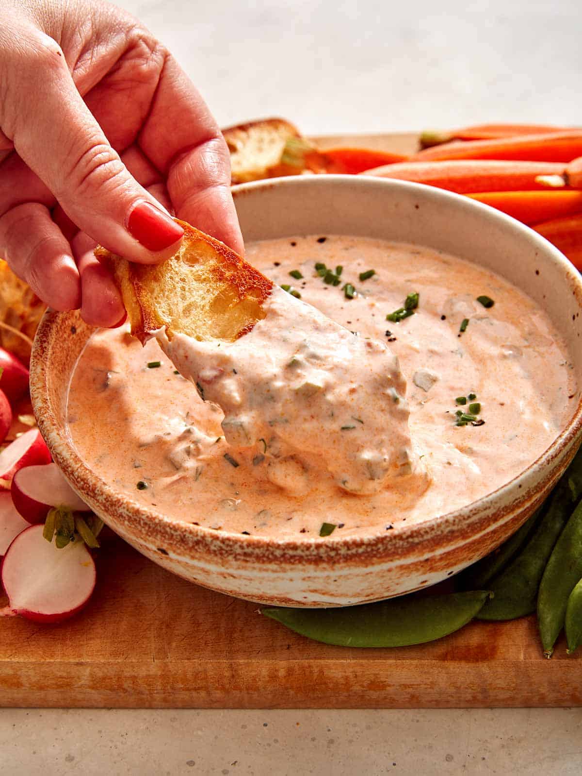 Spicy dill pickle dip recipe with crostini in it.
