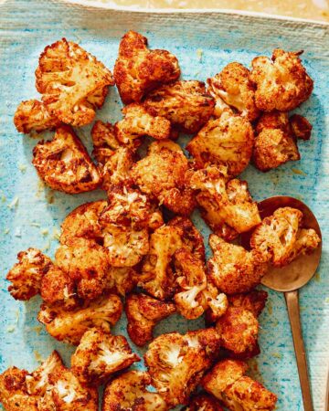 Air fryer cauliflower on a plate with a spoon.
