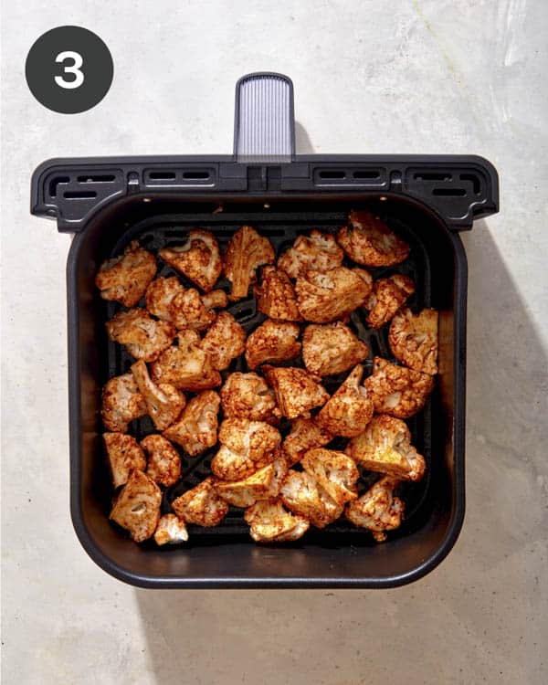 Cauliflower in an air fryer before its been cooked.