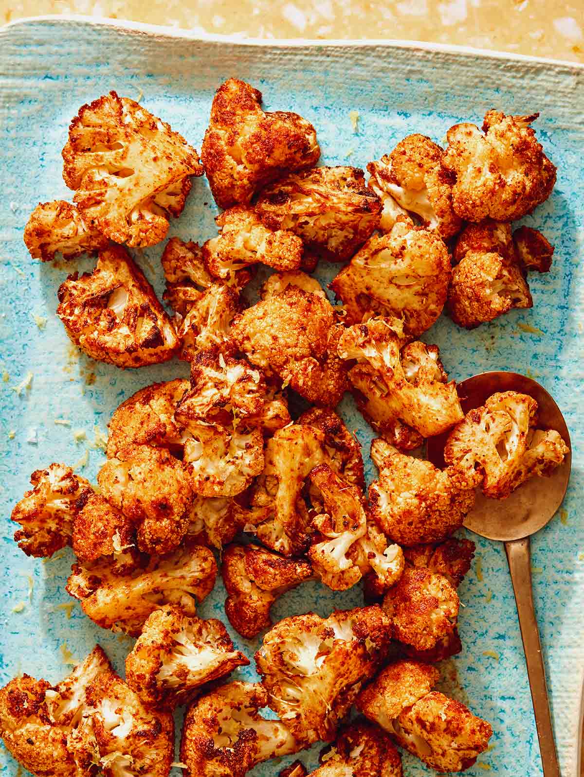 Air fryer cauliflower on a plate with a spoon. 