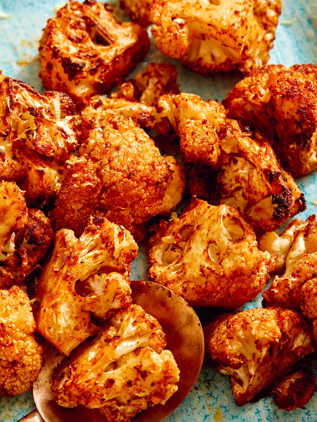 Air fryer cauliflower with a spoon on a plate. 