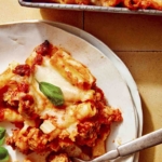 Baked ziti on a plate with a fork on it.
