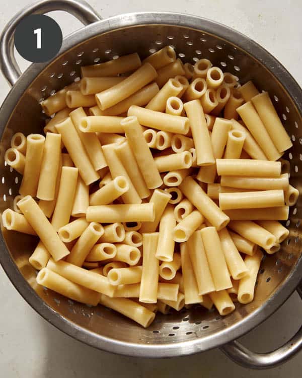 Pasta in a colander draining for baked ziti. 