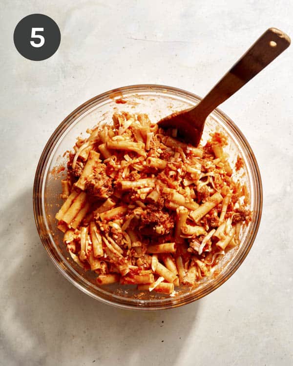 Baked ziti mixed in a bowl. 