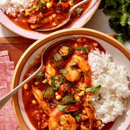 Chicken sausage gumbo recipe in two bowls with rice.