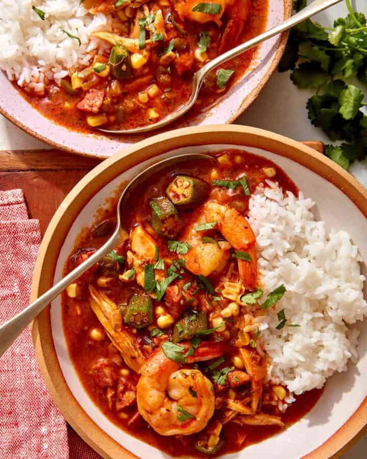 Chicken sausage gumbo recipe in two bowls with rice.