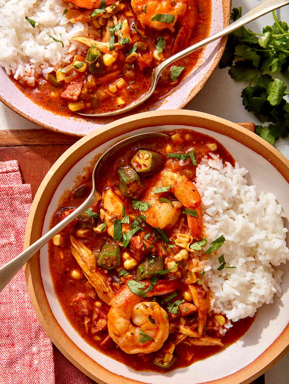 Chicken sausage gumbo recipe in two bowls with rice.