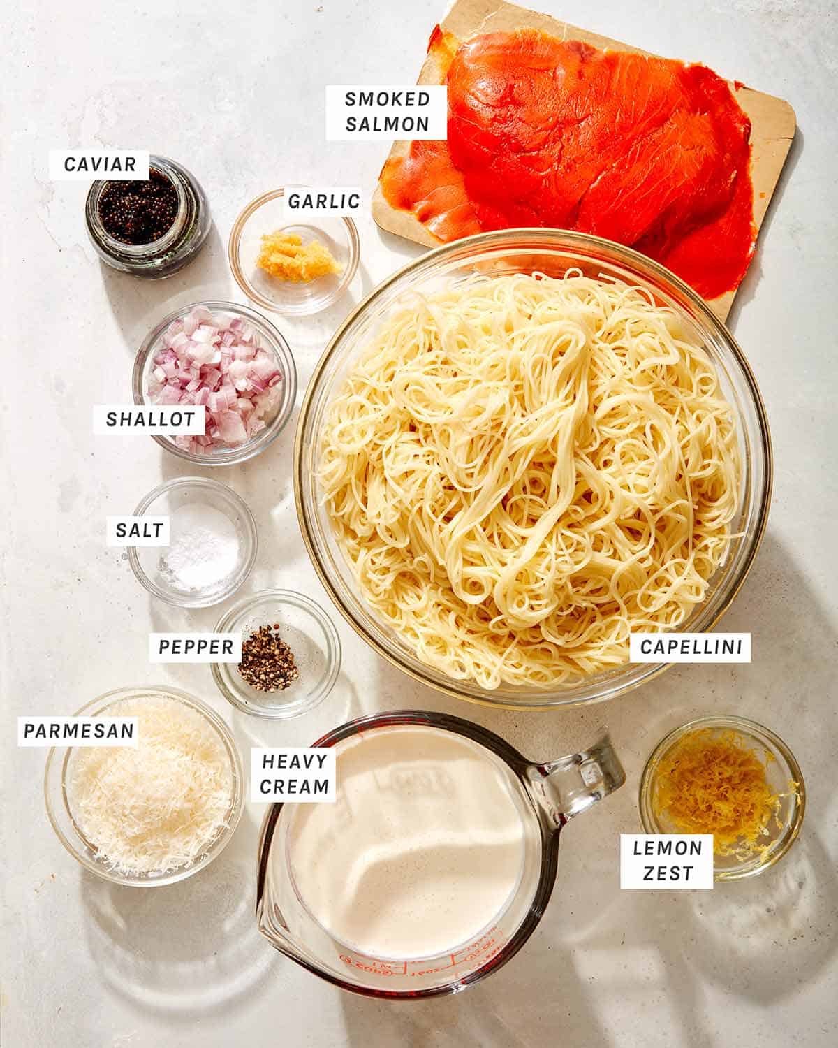 Smoked salmon pasta ingredients on a kitchen counter.