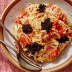 Smoked salmon pasta in two bowls with forks on the side.