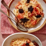 Smoked salmon pasta in two bowls with forks on the side.