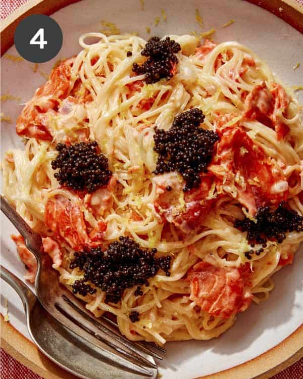 Smoked salmon pasta plated in a bowl with caviar. 