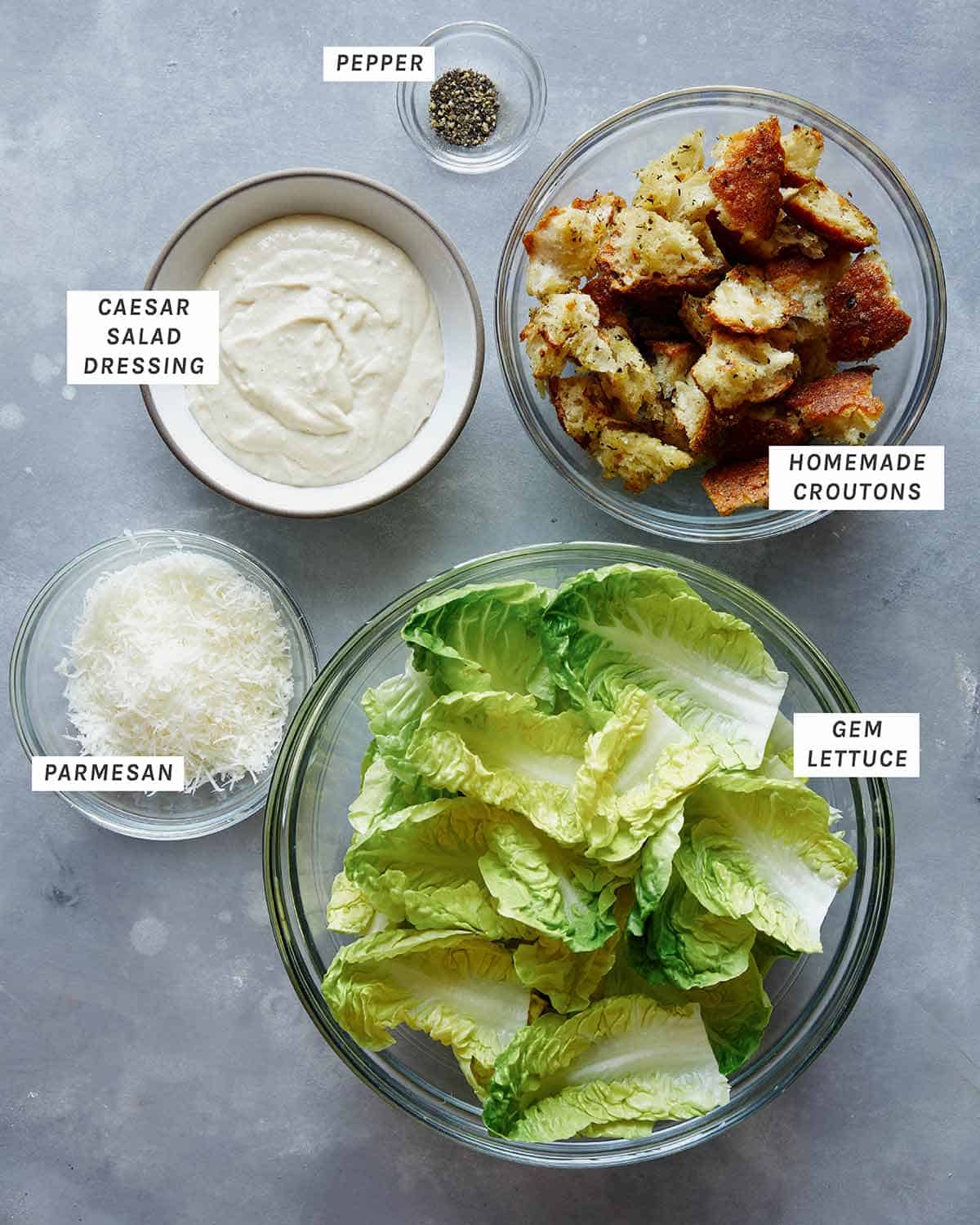 Caesar salad ingredients on a kitchen table.