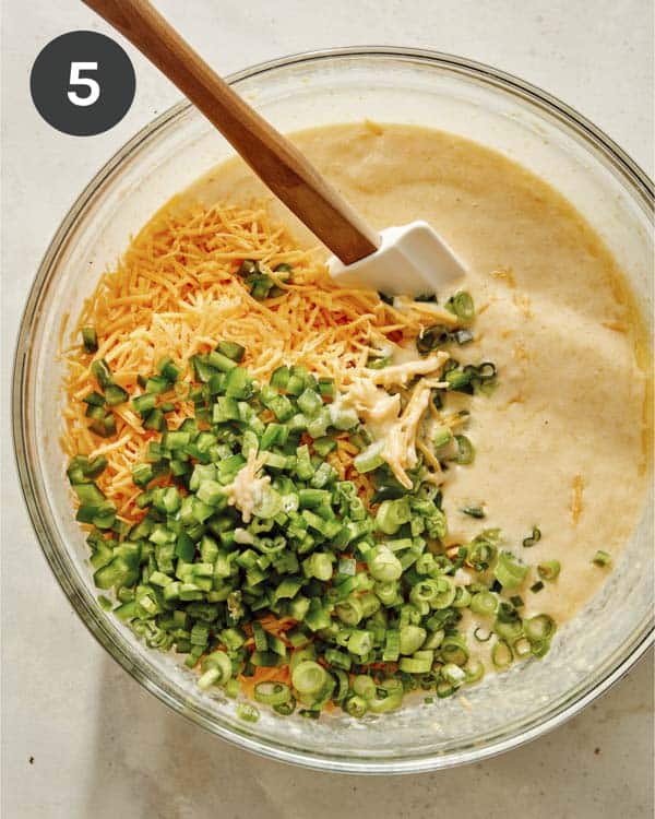 Mix ins being added to spoon bread batter.