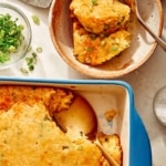 Jalapeno cheddar spoon bread in a baking dish with some served into a bowl.