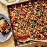 Salmon sushi bake in a baking dish with cucumbers and nori.