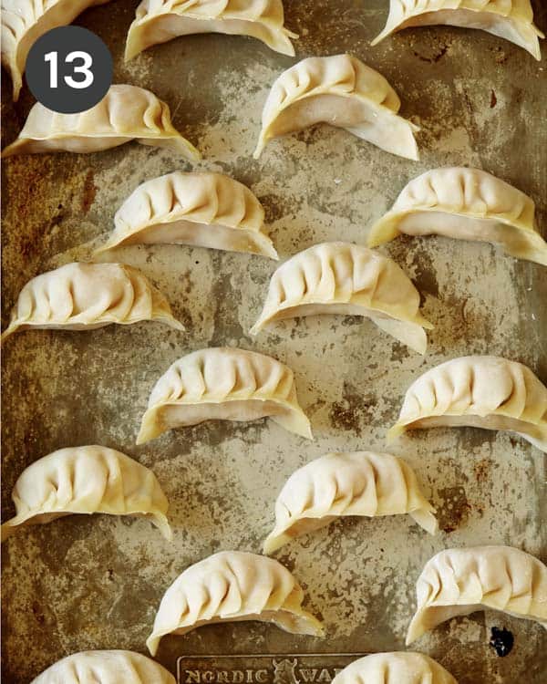 Potstickers on a baking sheet.