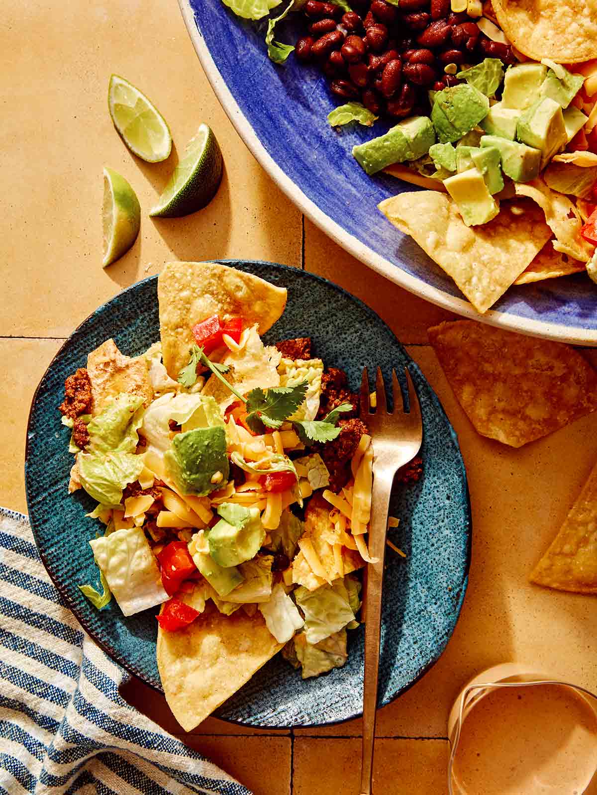 Taco salad served on a plate with a fork on the plate.