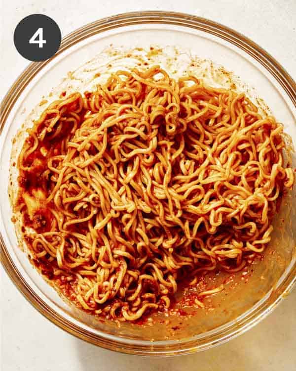 Spicy ramen noodles tossed together in a bowl. 