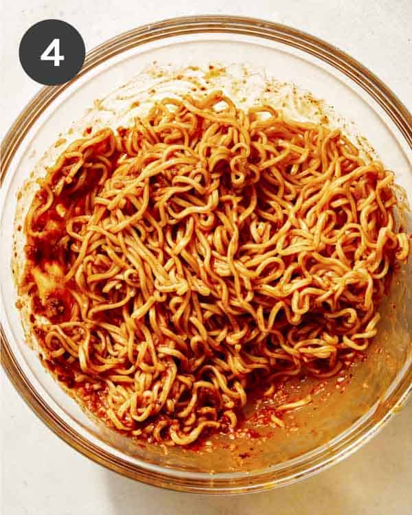 Spicy ramen noodles tossed together in a bowl.