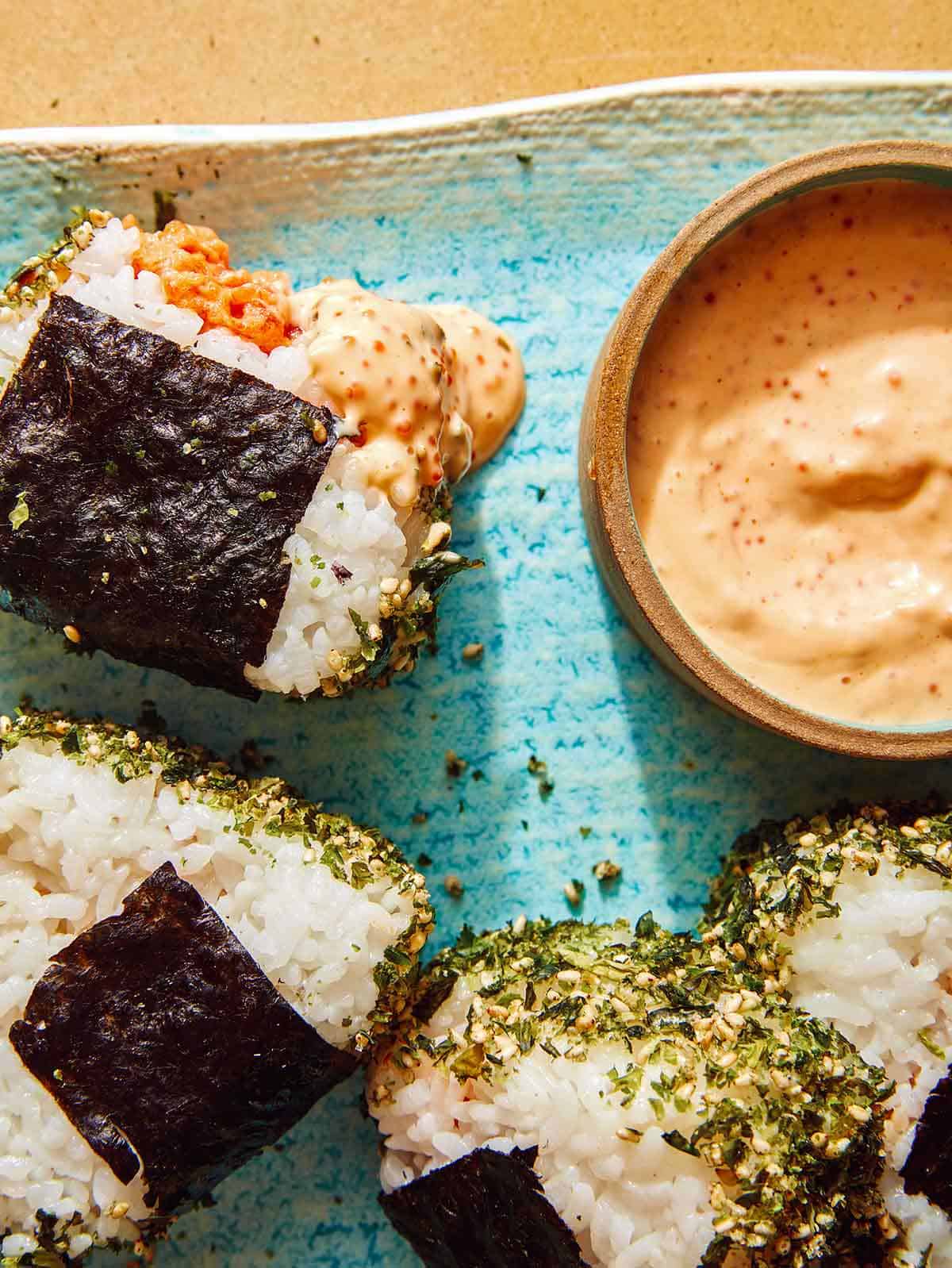 Spicy tuna onigiri close up on a plate.