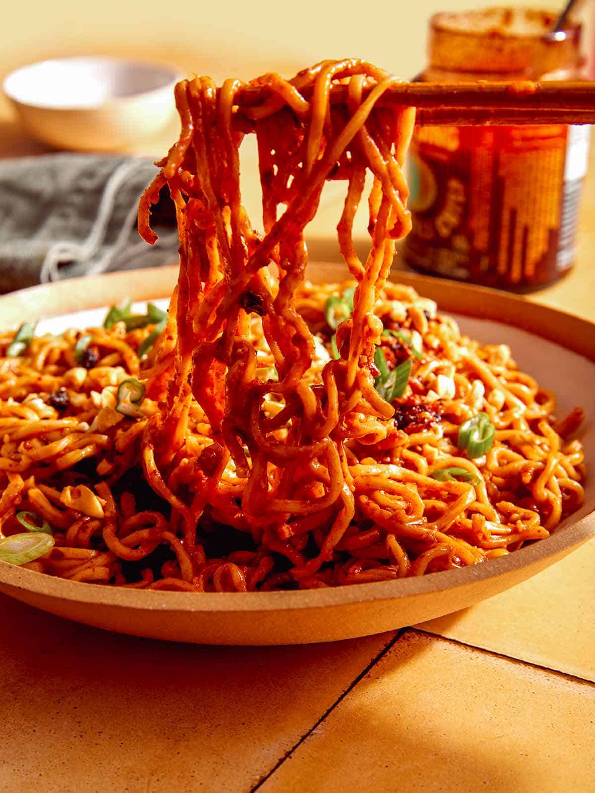 Spicy ramen noodles in a bowl with chopsticks.