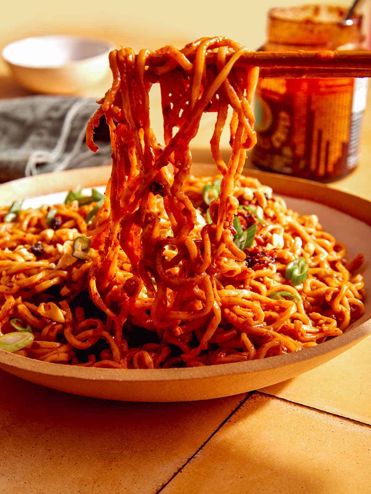 Spicy ramen noodles in a bowl with chopsticks. 